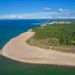 Plaża i las na Helu. Widok z lotu ptaka na turkusowe morze, piaszczysty brzeg i zielony las. Idealne miejsce na wakacyjne atrakcje.