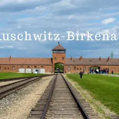 Brama wjazdowa do Auschwitz-Birkenau z torami kolejowymi prowadzącymi do obozu.