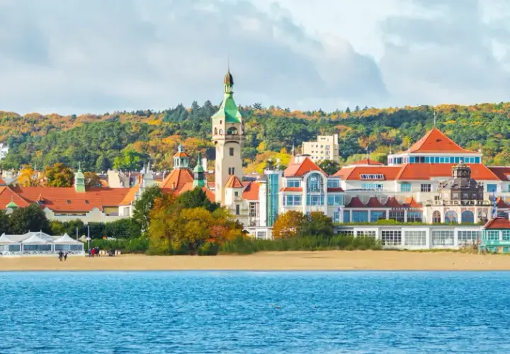 Sopot atrakcje: malowniczy widok na plażę, morze i zabytkowe budynki z wieżą widokową w jesiennej scenerii.