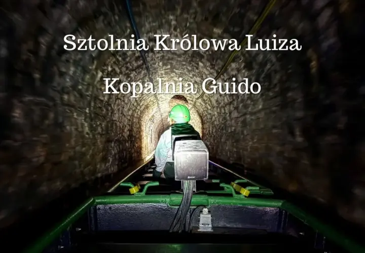 Osoba w kasku jedzie kolejką w ciemnej sztolni Królowa Luiza, Kopalnia Guido.