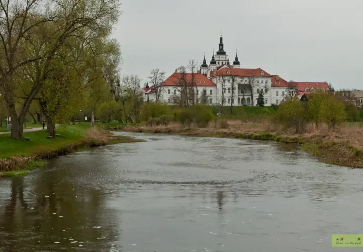 Malowniczy widok na rzekę i klasztor w Supraślu. Wiosna budzi do życia przyrodę, a zabytkowa architektura zaprasza do odkrywania supraśl atrakcje.