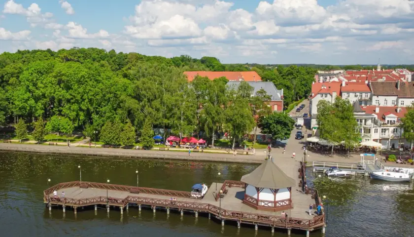 Idealne miejsce, gdzie na wakacje z dziećmi: malownicze miasteczko nad jeziorem z promenadą, molo i zielonymi terenami.