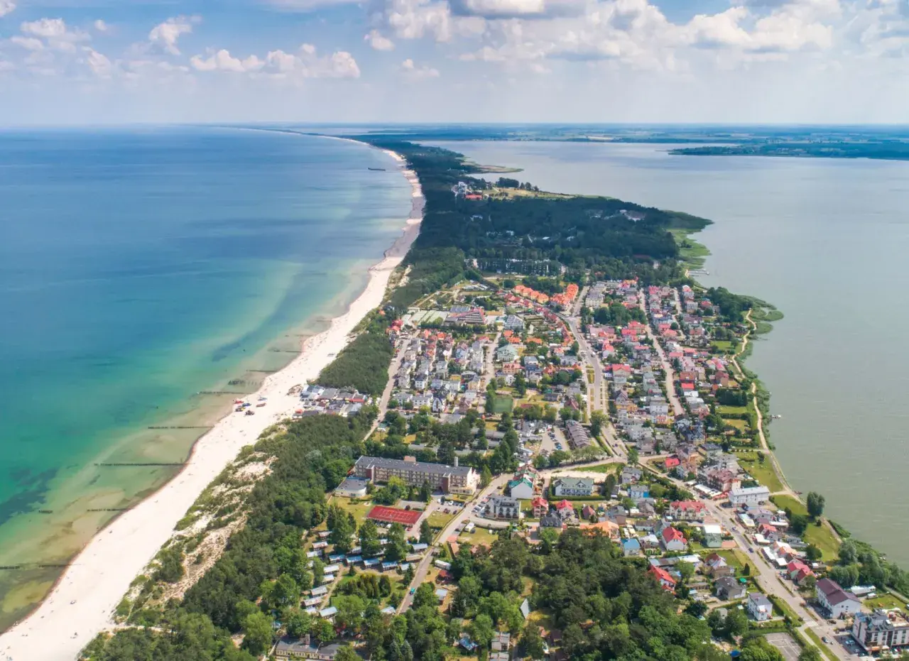 Mielno atrakcje: malownicze widoki na plażę, morze i jezioro Jamno. Urokliwe miasteczko z kolorowymi domkami i zielonymi terenami.