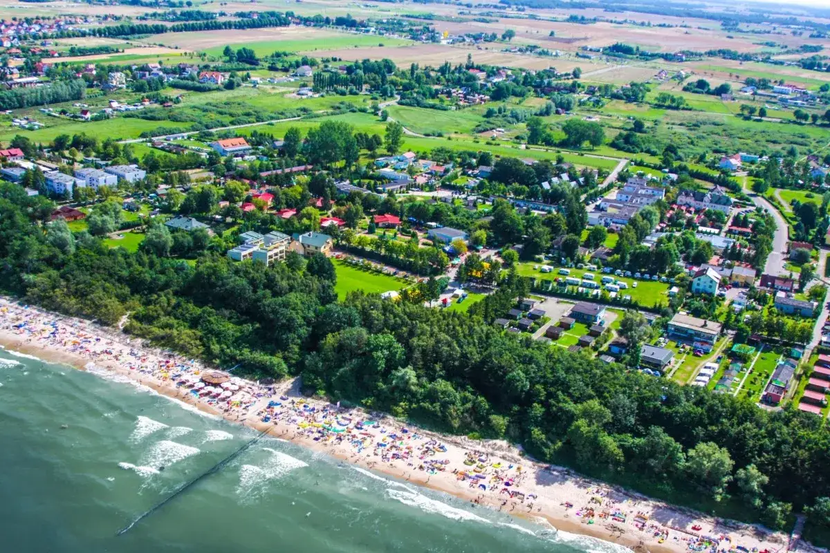Sianożęty oferują plażowe atrakcje: tłumy wczasowicz&oacute;w na piasku, zielone tereny i morze.